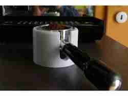 Tamper station for portafilter coffee machine